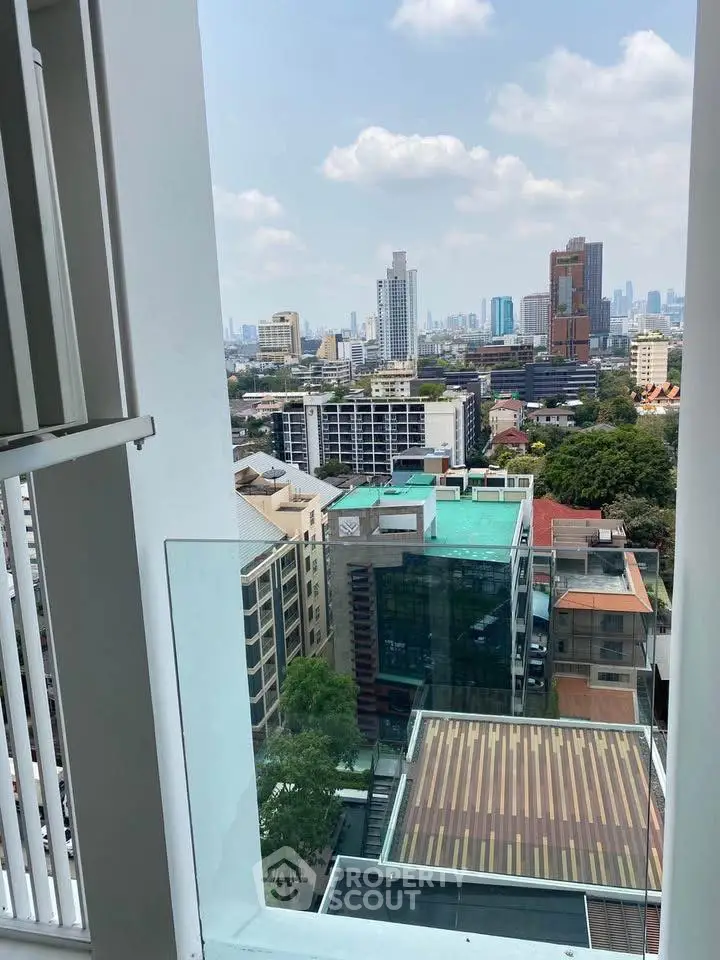 Stunning cityscape view from high-rise balcony with modern urban skyline.