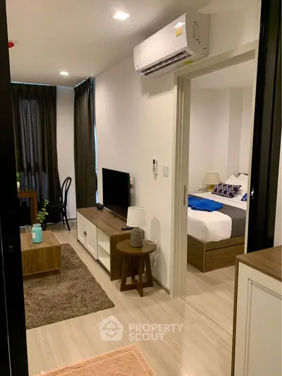 Modern apartment interior with cozy living room and bedroom, featuring stylish furniture and natural lighting.