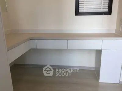 Modern minimalist study room with built-in desk and neutral tones