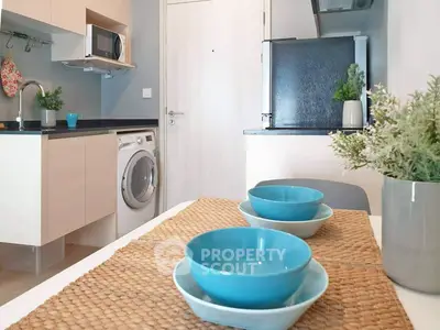 Modern kitchen with washing machine and sleek appliances in cozy apartment