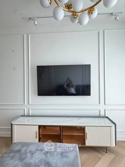 Modern living room with wall-mounted TV and elegant furniture
