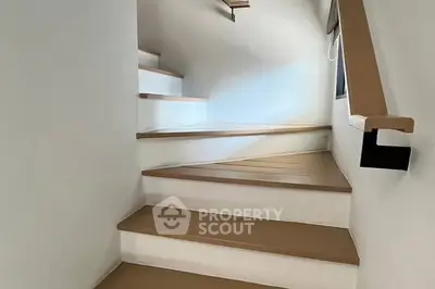 Modern staircase with sleek wooden steps and minimalist design