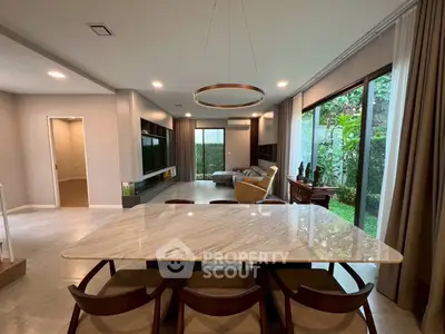 Spacious modern living room with garden view and elegant dining area