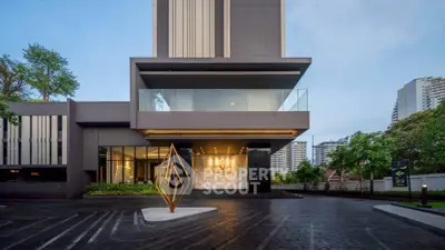 Modern luxury building entrance with sleek design and elegant lighting