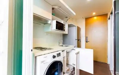 Compact modern kitchen with integrated appliances and washing machine