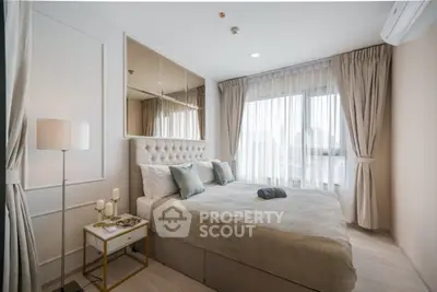 Luxurious bedroom with elegant decor and large window offering city views