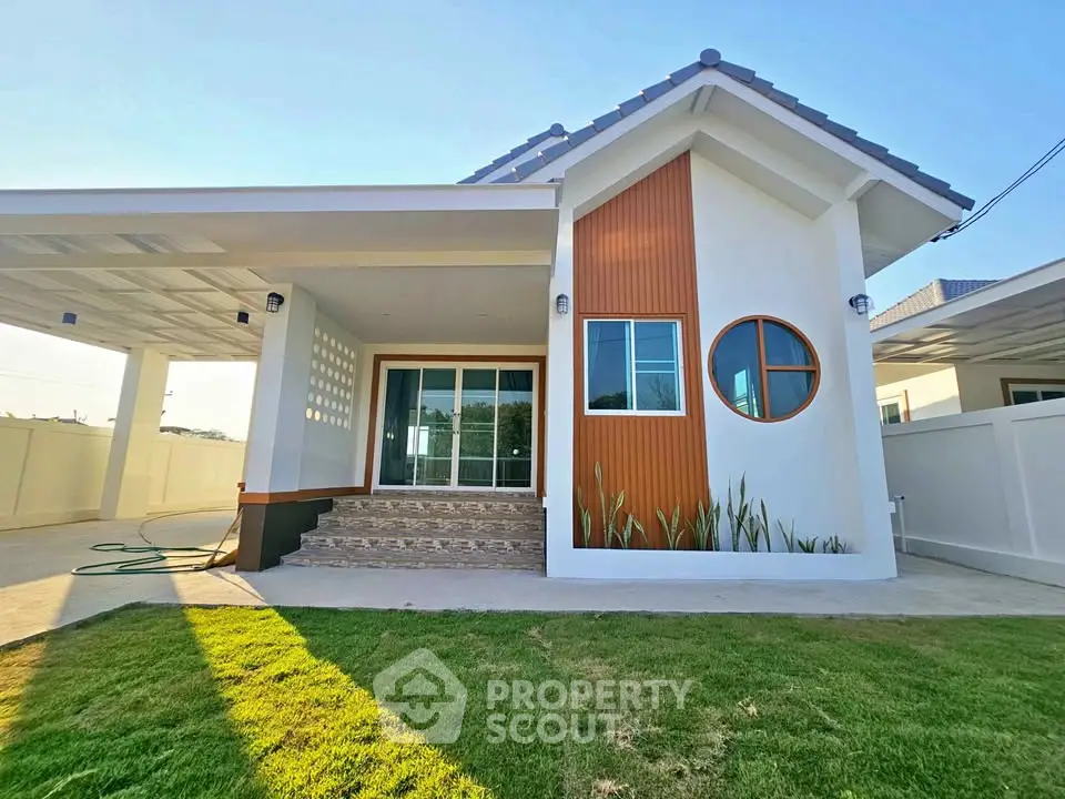 Charming modern house with unique circular window and spacious carport