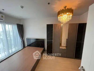 Spacious bedroom with elegant chandelier and modern wardrobe