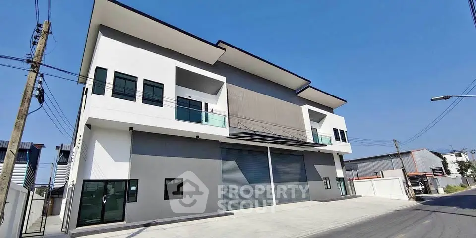 Modern commercial building with large garage doors and sleek design