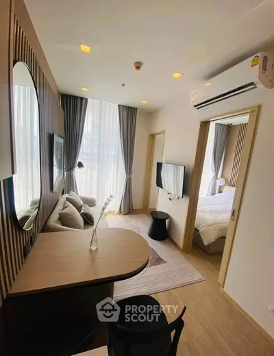 Modern apartment interior with cozy living room and stylish bedroom, featuring elegant decor and natural light.