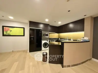 Modern kitchen with sleek appliances and open layout in luxury apartment