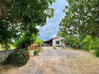 Charming countryside home with lush garden and spacious driveway, perfect for serene living.
