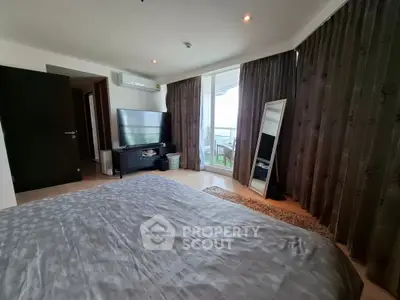 Spacious bedroom with balcony access and modern decor