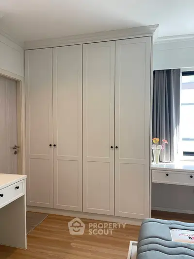 Spacious bedroom with built-in wardrobe and natural light