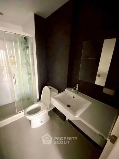 Modern bathroom with sleek fixtures and glass shower enclosure