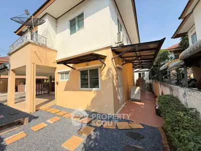 Charming two-story house with satellite dish and covered patio in sunny neighborhood