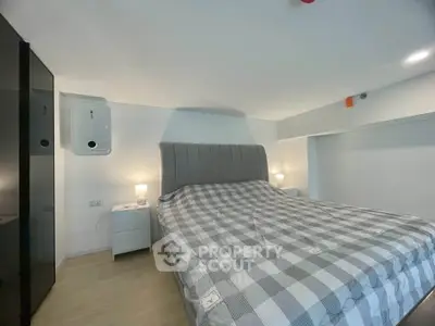 Modern bedroom with stylish bed and sleek design, perfect for a cozy retreat.