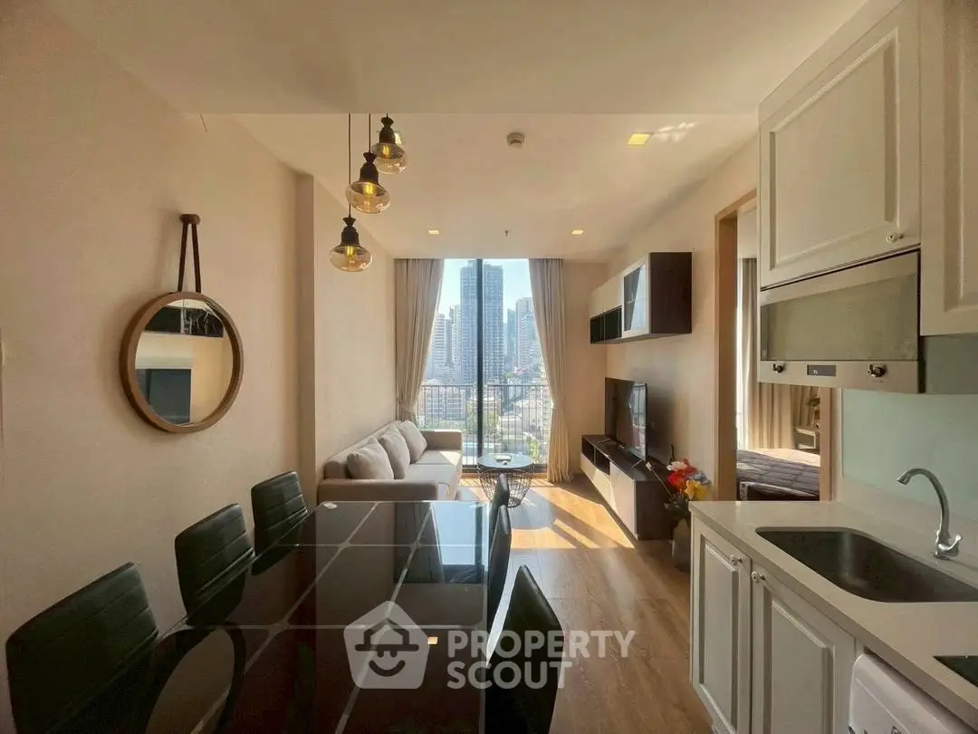 Modern living room with city view, open kitchen, and stylish decor in a high-rise apartment.