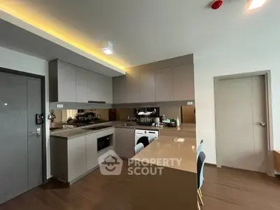 Modern kitchen with sleek cabinetry and integrated appliances in a stylish apartment.