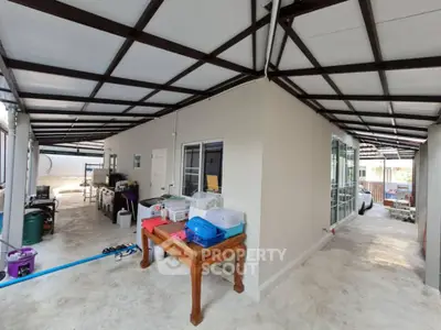 Spacious covered outdoor area with modern design and ample natural light.