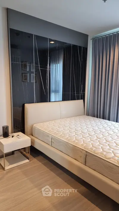Modern bedroom with stylish decor and large bed in a luxury apartment.