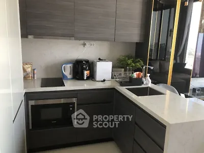 Modern kitchen with sleek cabinetry and built-in appliances in a stylish apartment.