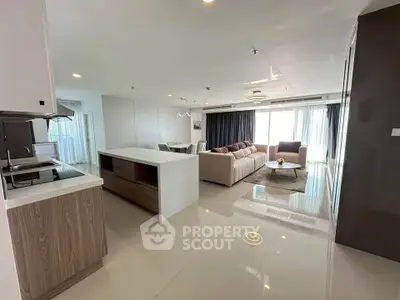 Spacious modern living room with open kitchen and elegant furnishings