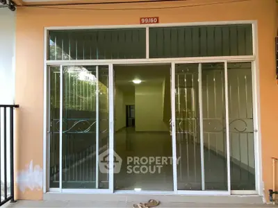 Spacious entrance with glass sliding doors leading to a bright interior, perfect for modern living.