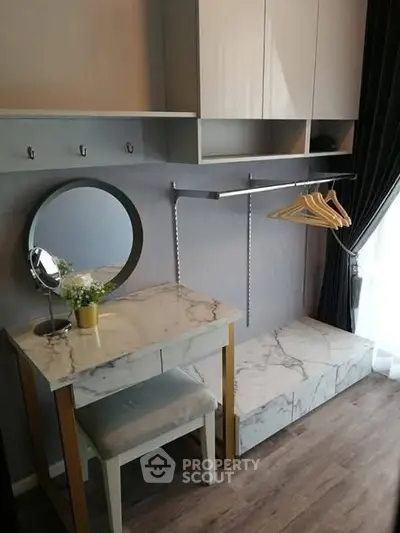 Stylish modern dressing area with marble accents and ample storage space.