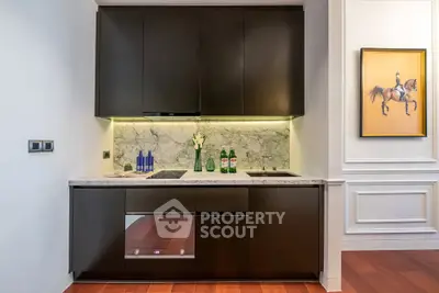 Modern kitchen with sleek cabinetry and marble backsplash in luxury apartment