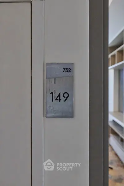 Modern apartment entrance with sleek door number signage and minimalist design.