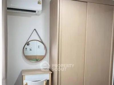 Cozy bedroom corner with air conditioning and stylish mirror