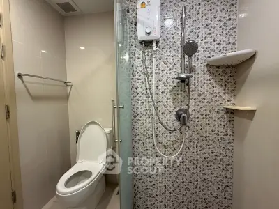 Modern bathroom with stylish shower and toilet in a contemporary apartment.