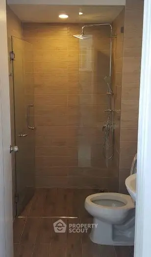 Modern bathroom with glass shower and wooden tile design