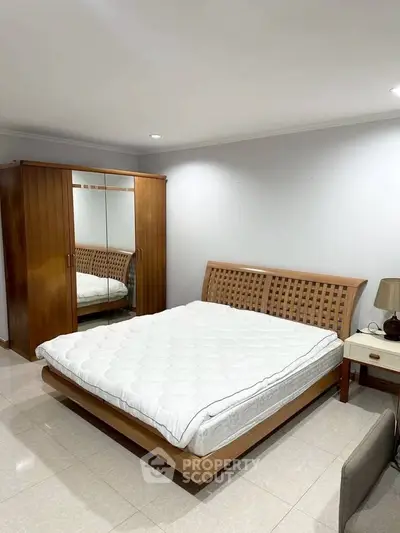 Spacious bedroom with elegant wooden furniture and cozy ambiance