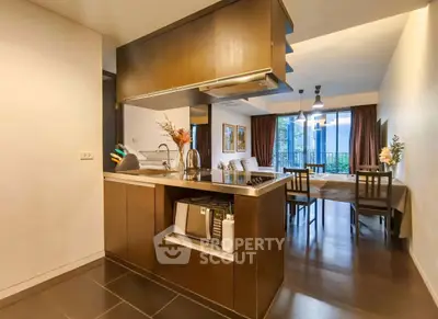 Modern open kitchen with dining area and large windows in stylish apartment