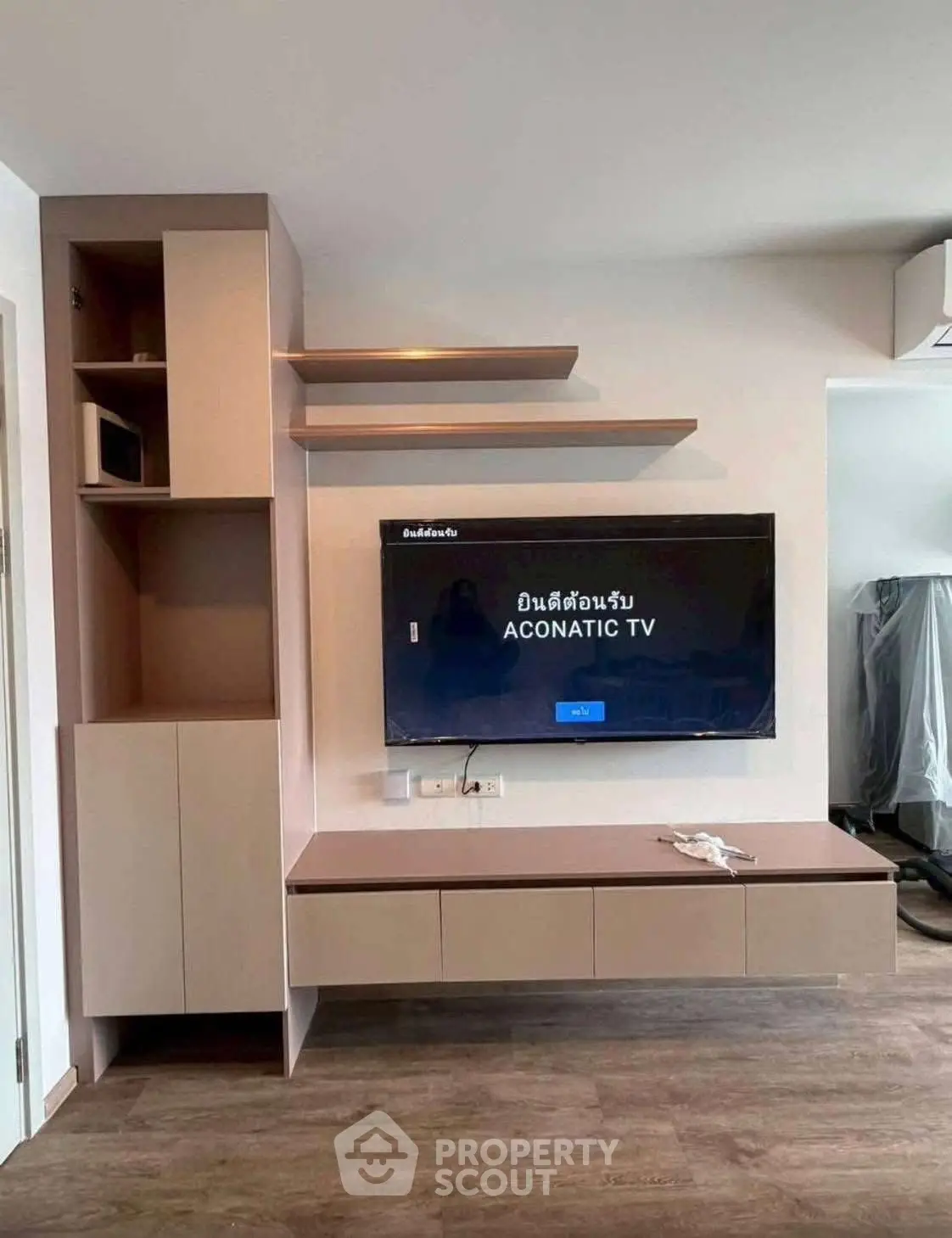 Modern living room with sleek TV setup and stylish shelving unit.