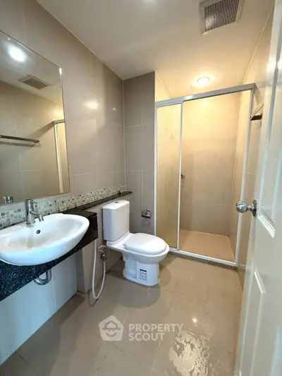 Modern bathroom with sleek fixtures and spacious shower area