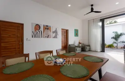 Spacious dining area with modern decor and outdoor access, perfect for entertaining.