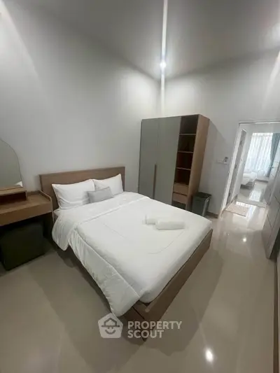 Modern bedroom with sleek furniture and cozy ambiance, perfect for relaxation and comfort.