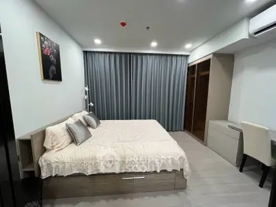 Modern bedroom with stylish decor and ample storage in a contemporary apartment.