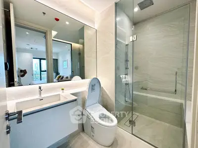 Modern bathroom with glass shower and sleek fixtures in luxury apartment