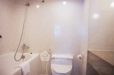 Modern bathroom with bathtub and sleek fixtures in a stylish home.