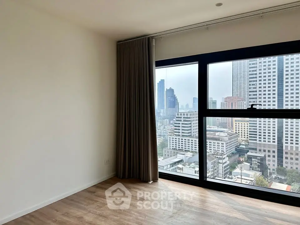 Spacious corner unit with stunning city view and large windows in modern apartment.