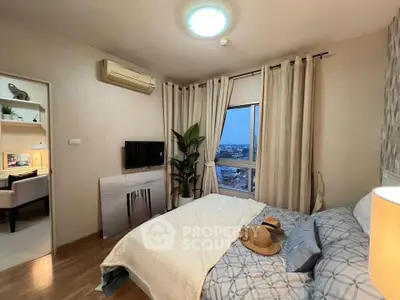 Cozy bedroom with city view, modern decor, and natural light.