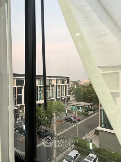 Modern urban view from window with contemporary buildings and street scene.