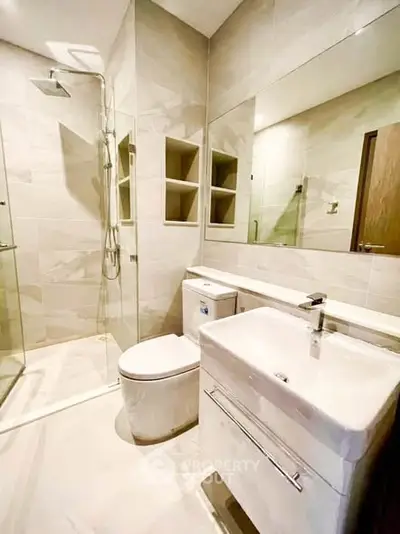 Modern bathroom with sleek fixtures and spacious shower area.
