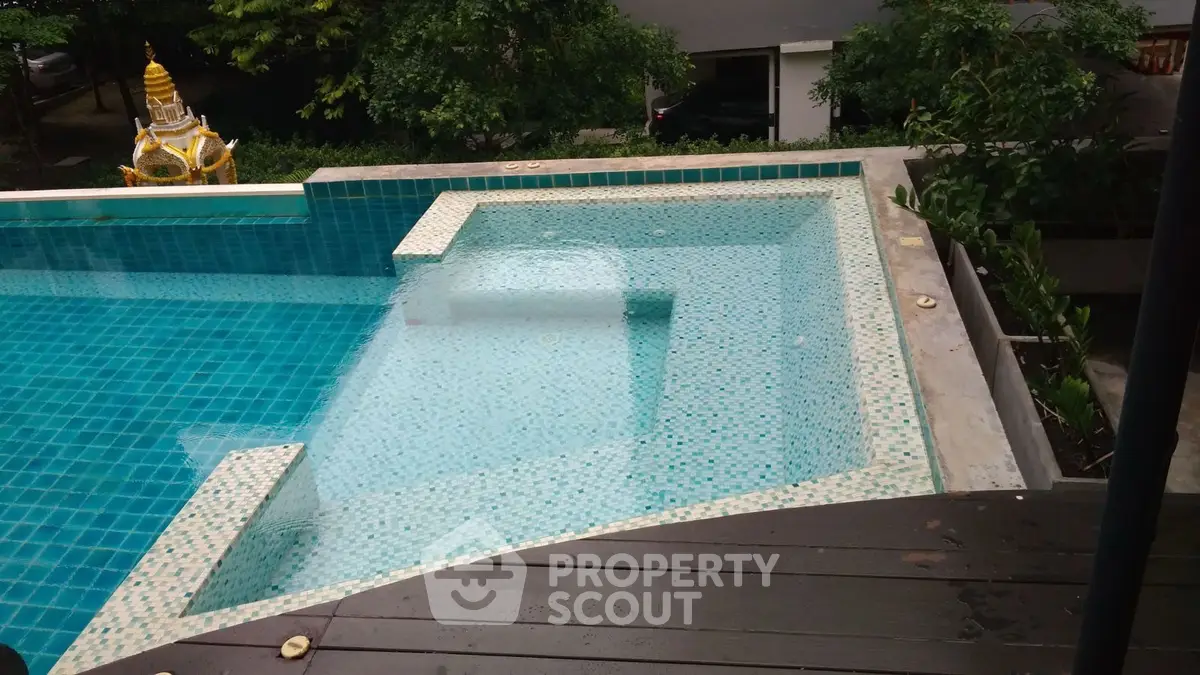 Luxurious infinity pool with serene garden view, perfect for relaxation and leisure.