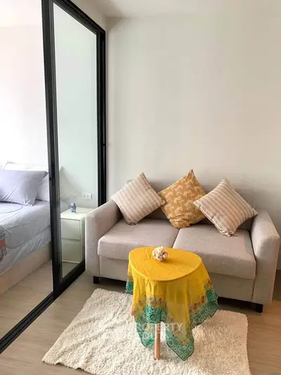 Cozy living room with modern sofa and vibrant decor in a stylish apartment.