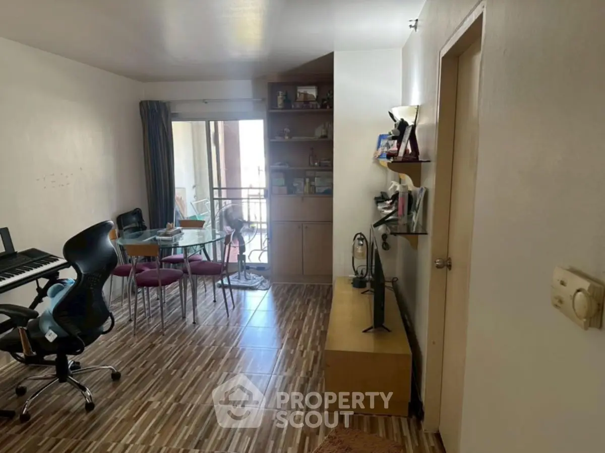 Spacious living room with modern decor and balcony access